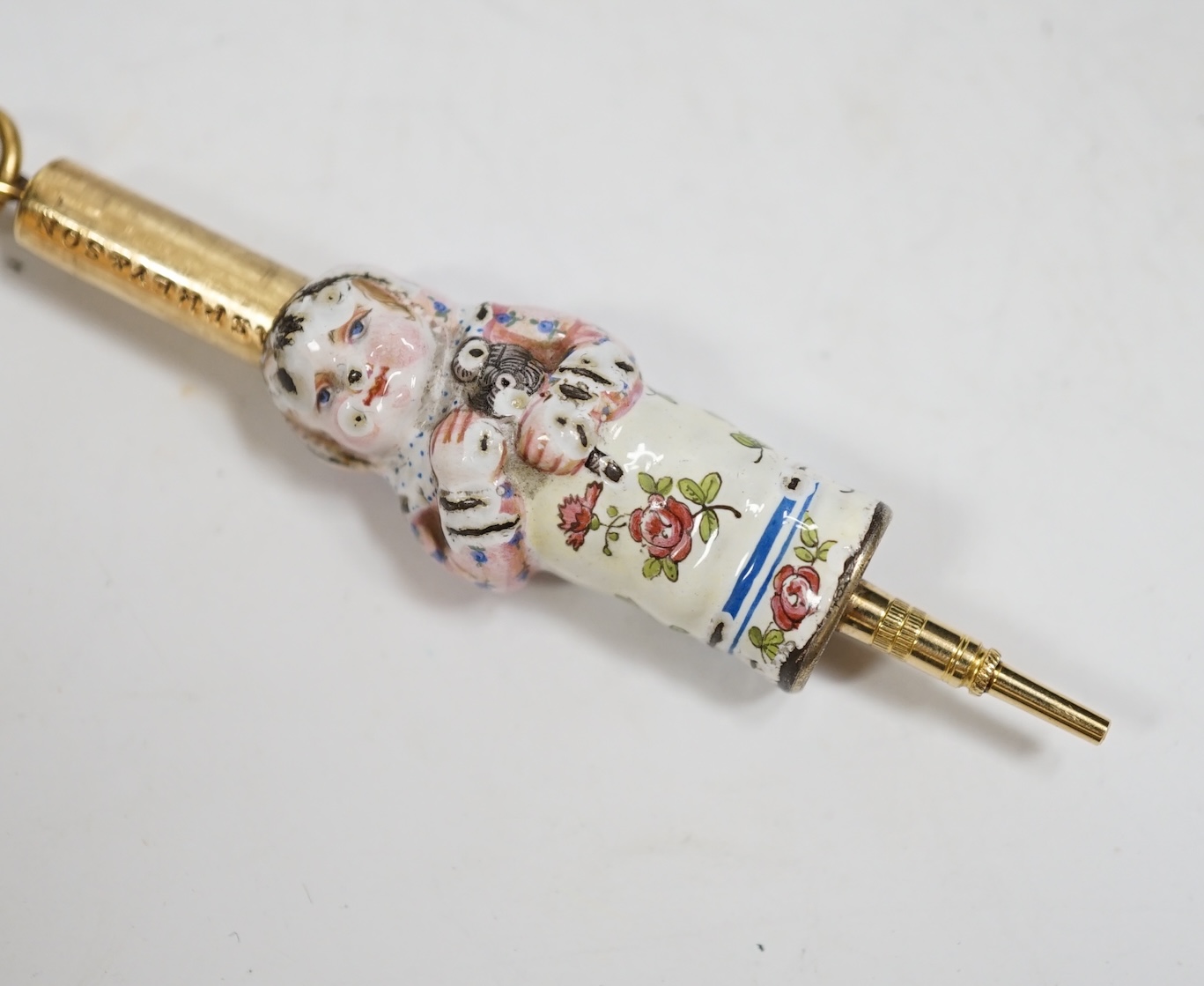A rare Asprey and Son gilt metal and enamel novelty propelling pencil, c.1875, modelled as an infant holding a rattle. Condition - fair, losses to enamel